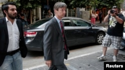 European Commission Director Matthias Morse, center, arrives at finance ministry, Athens, July 2, 2013.