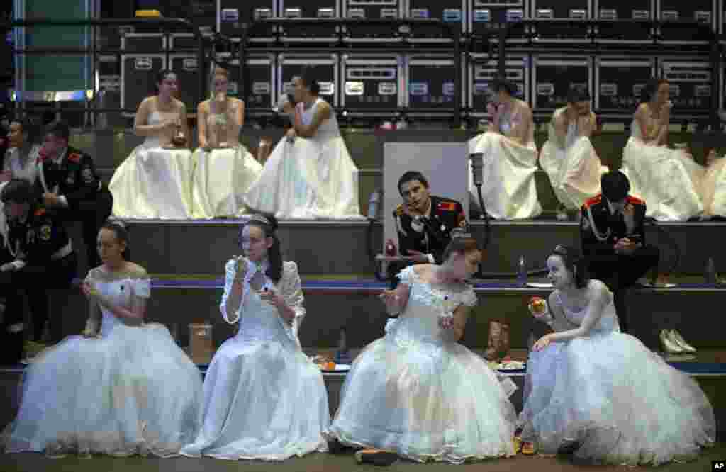 Participants at a ball for military school students sit backstage during an annual ball in Moscow, Russia.