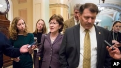 Sen. Susan Collins, R-Maine, left, and Sen. Mike Rounds, R-S.D., leave a meeting in the office of Senate Majority Leader Mitch McConnell, R-Ky., as Day 2 of the federal shutdown drags on, at the Capitol in Washington, Sunday, Jan. 21, 2018.