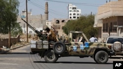 A Houthi Shiite rebel mans a machine gun mounted on a military truck in Sanaa, Yemen, Oct. 20, 2014.