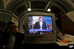 FILE - Sen. Ted Cruz, R-Texas, is seen on a television in the Senate Press Gallery as he speaks during the seventh hour of his filibuster on the Senate floor at the U.S. Capitol in Washington, D.C., Sept. 24, 2013.