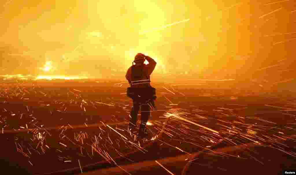 Fire photographer Tod Sudmeier gets hit with flying embers from strong winds at the Solimar brush fire in Ventura County, California, Dec. 26, 2015.&nbsp;A wildfire in Southern California burned over 1,000 acres of land, forced the closure of parts of two major highways and led to evacuations, fire officials said.&nbsp;