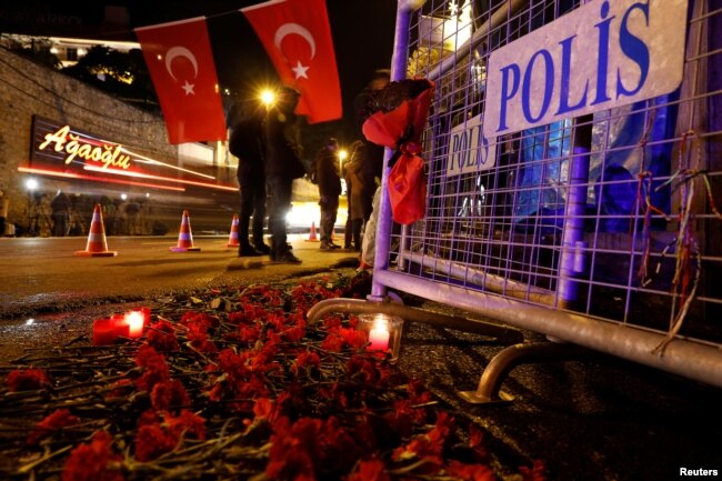 Flowers are placed in front of a police barrier near the entrance of Reina nightclub by the Bosphorus, which was attacked by a gunman, in Istanbul, Turkey, Jan. 1, 2017.