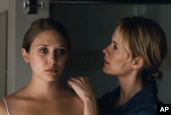 Elizabeth Olsen (left) and Sarah Paulson, as the sister who takes her in, in "Martha Marcy May Marlene."