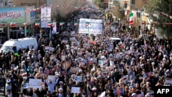 Pro-government demonstrators march in Iran's holy city of Qom, some 130 kilometers south of Tehran, on Jan. 3, 2018, as tens of thousands gathered across Iran in a massive show of strength for the Islamic rulers after days of deadly unrest.