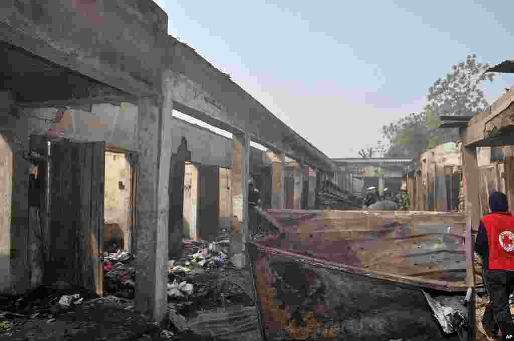 Des personnes inspectent des magasins endommagés par l&#39;explosion d&#39;une bombe lundi sur un marché de Bauchi, au Nigeria. 