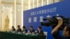 FILE - Chinese officials answer questions about a law regulating overseas non-governmental organizations (NGOs) during a press conference at the Great Hall of the People in Beijing, China, April 28, 2016. 