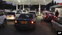 FILE: Motorists wait to fill up their tanks at a fuel station in Harare. (AP Photo/Tsvangirayi Mukwazhi)