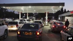 FILE: Motorists wait to fill up their tanks at a fuel station in Harare, Tuesday, Oct, 9, 2018.