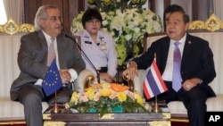 FILE - European Union delegation chief Cesar Deben, left, meets Thai Deputy Prime Minister and Defense Minister Prawit Wongsuwan in Bangkok, Thailand, Jan. 22, 2016. The EU is maintaining the threat of a seafood import ban on Thailand.