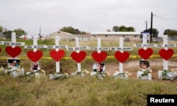 A line of crosses in remembrance of the eight members of the Holcombe family killed in the shooting at the First Baptist Church of Sutherland Springs, Texas, Nov. 9, 2017.