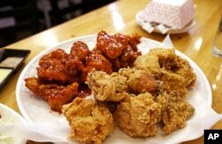 FILE - Korean-style fried chicken sits waiting to be eaten at a restaurant in Edmonds, Washington, Dec. 12, 2017.
