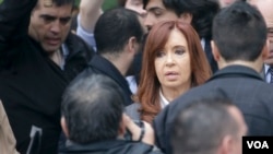 FILE - Former Argentine President Cristina Fernandez de Kirchner leaves court in Buenos Aires, April 13, 2016, after refusing to testify in a state fraud probe. On Thursday, Argentine police searched three of her properties seeking documents.