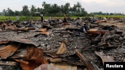 FILE - The ruins of a market that was set on fire are seen at a Rohingya village outside Maugndaw in Rakhine state, Myanmar, Oct. 27, 2016. 