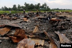 FILE - The ruins of a market that was set on fire are seen at a Rohingya village outside Maugndaw in Rakhine state, Myanmar, Oct. 27, 2016.