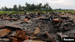 FILE - The ruins of a market that was set on fire are seen at a Rohingya village outside Maugndaw in Rakhine state, Myanmar, Oct. 27, 2016. 