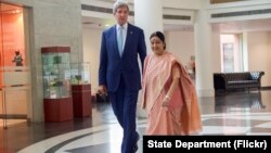 U.S. Secretary of State John Kerry walks with Indian Minister of External Affairs Shushma Swaraj on August 30, 2016, after he arrives at the Jawarhalal Nehru Bhawan in New Delhi, India, for a bilateral meeting.