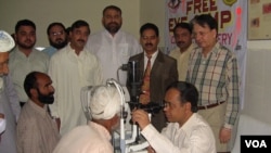 Dr. Ghulam Hussain Asif examines patients during a free clinic.