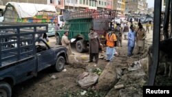 Members of the bomb disposal unit survey the site after a blast at a vegetable market in Quetta, Pakistan, April 12, 2019.