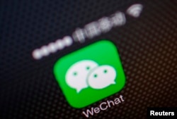 FILE - A picture illustration shows a WeChat app icon in Beijing, Dec. 5, 2013.