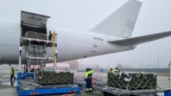 Workers and Ukrainian servicemen unload a shipment of ammunition delivered as part of U.S. security assistance to Ukraine, at the Boryspil International Airport outside Kyiv, Ukraine November 14, 2021. (Press service of the U.S. Embassy in Ukraine/Handout