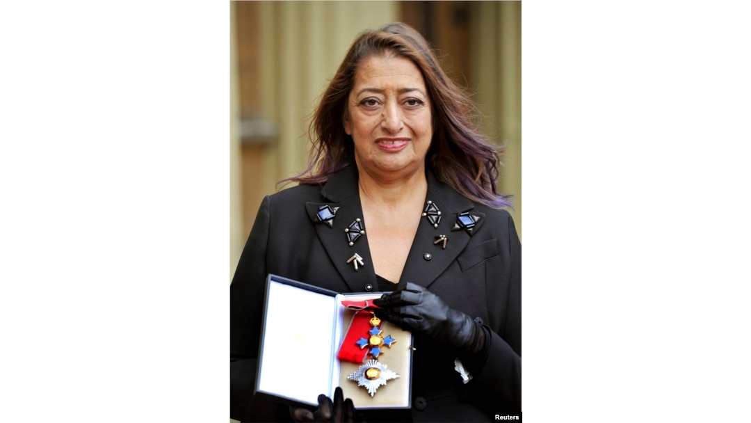 FILE - Architect Zaha Hadid poses for photographs with her Dame Commander of the Order of the British Empire (DBE) medal, after it was awarded to her by Britain's Princess Anne during an Investiture Ceremony at Buckingham Palace, in London, Nov. 7, 2012.