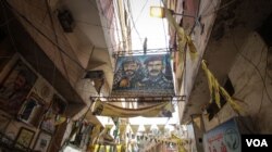 Flags and banners bearing the Palestinian insignia and political figures line Bourj el Barajneh, one of 12 Palestinian camps in Lebanon. (J. Owens/VOA)