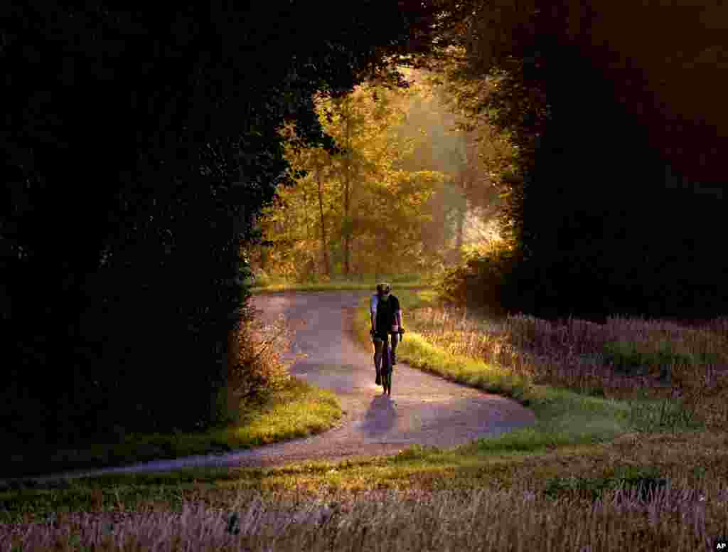 A man rides his bicycle on a small road outside of Frankfurt, Germany.