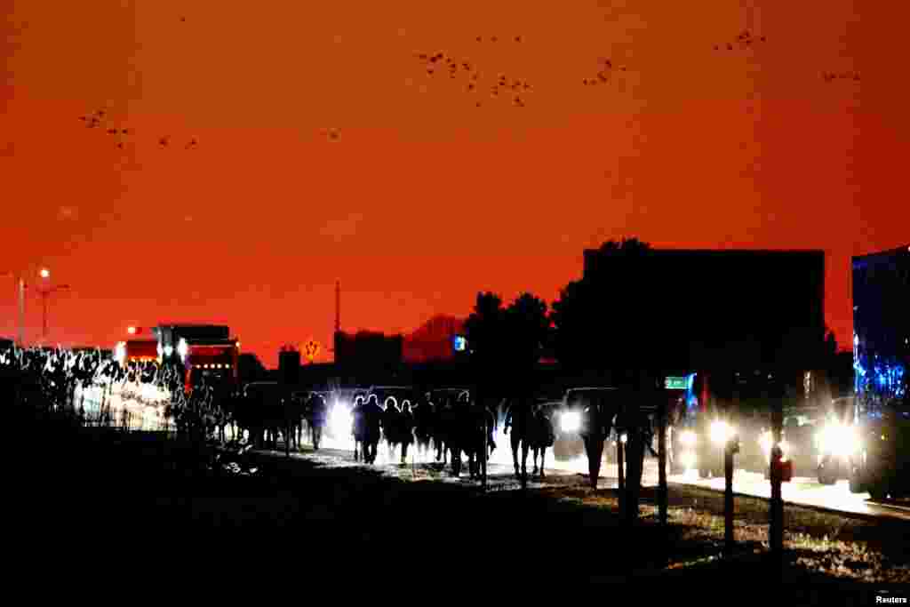 Supporters of U.S. President Donald Trump walk along Wisconsin Highway 158 (WI-158) on their way to his penultimate campaign rally at the Kenosha Regional Airport in Kenosha, Wisconsin, Nov. 2, 2020.