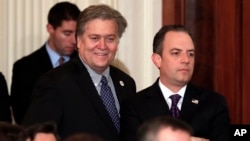 FILE - Steve Bannon, chief White House strategist to President Donald Trump, left, and then-White House Chief of Staff Reince Priebus stand in the East Room of the White House in Washington, Jan. 31, 2017.