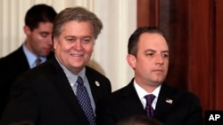 FILE - Steve Bannon, chief White House strategist to President Donald Trump, left, and White House Chief of Staff Reince Priebus stand in the East Room of the White House in Washington.