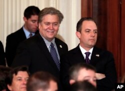 FILE - Steve Bannon, chief White House strategist to President Donald Trump, left, and White House Chief of Staff Reince Priebus stand in the East Room of the White House in Washington, Jan. 31, 2017.
