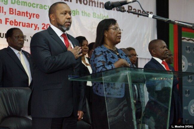 Vice President Saulos Chilima (left) and MEC chairperson Jane Ansah and others standing attention for the Malawi National Anthem during the nominantion presentation ceremony in Blantryre.