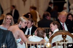 Ivanka Trump talks with her kids as she has Thanksgiving Day dinner at their Mar-a-Lago estate in Palm Beach, Fla., Nov. 22, 2018, with President Donald Trump, left, and sister Tiffany Trump, background left.
