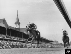 FILE - Secretariat, with jockey Ron Turcotte up, passes the twin spires of Churchill Downs during the running of the 99th Kentucky Derby in Louisville, Ky. on May 5, 1973. (AP Photo)