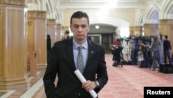 FILE - Romania's Prime Minister Sorin Grindeanu leaves a meeting at the parliament in Bucharest, Feb. 6, 2017.