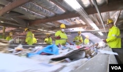 At Duong's recycling facility, employees and complex machines now do the sorting his family once did by hand.