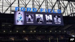 Scoreboard is seen during a moment of silence honoring the students killed at the high school this week, during pregame of an NFL football game between the Minnesota Vikings and the Detroit Lions, Dec. 5, 2021, 