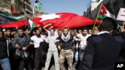 Anti-government protesters shout slogans during a demonstration after Friday prayers in Amman, Jordan, March 04, 2011