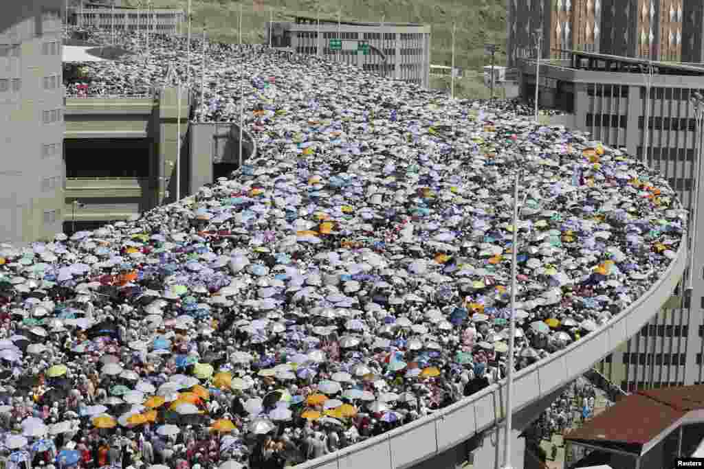 Muslim pilgrims walk on a bridge as they head to cast stones at pillars symbolizing Satan during the final day of the annual haj pilgrimage in Mina, near the holy city of Mecca.