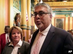 Rep. Sam Singh, D-East Lansing, right, speaks to reporters after being elected as the next House minority leader in Lansing, Mich., Nov. 10, 2016. Rep. Christine Greig, D-Northville, left, who was chosen to be the minority floor leader, looks on.