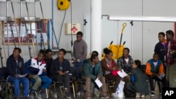 Eritrean refugees wait in a hanger to depart to Sweden. The EU hopes to reduce the number of Eritrean migrants and refugees through aid programs aimed at stabilizing the country.