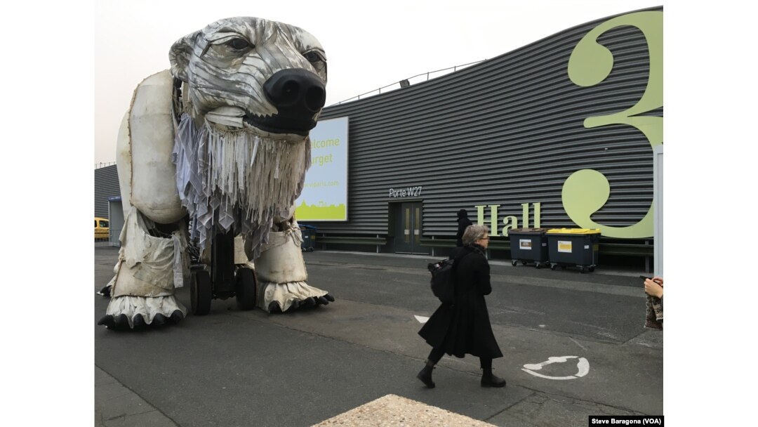 A giant mechanical polar bear made by the environmental group Greenpeace awaits delegates at the entrance to the Paris climate talks, Dec. 10, 2015.