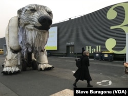 A giant mechanical polar bear made by the environmental group Greenpeace awaits delegates at the entrance to the Paris climate talks, Dec. 10, 2015.