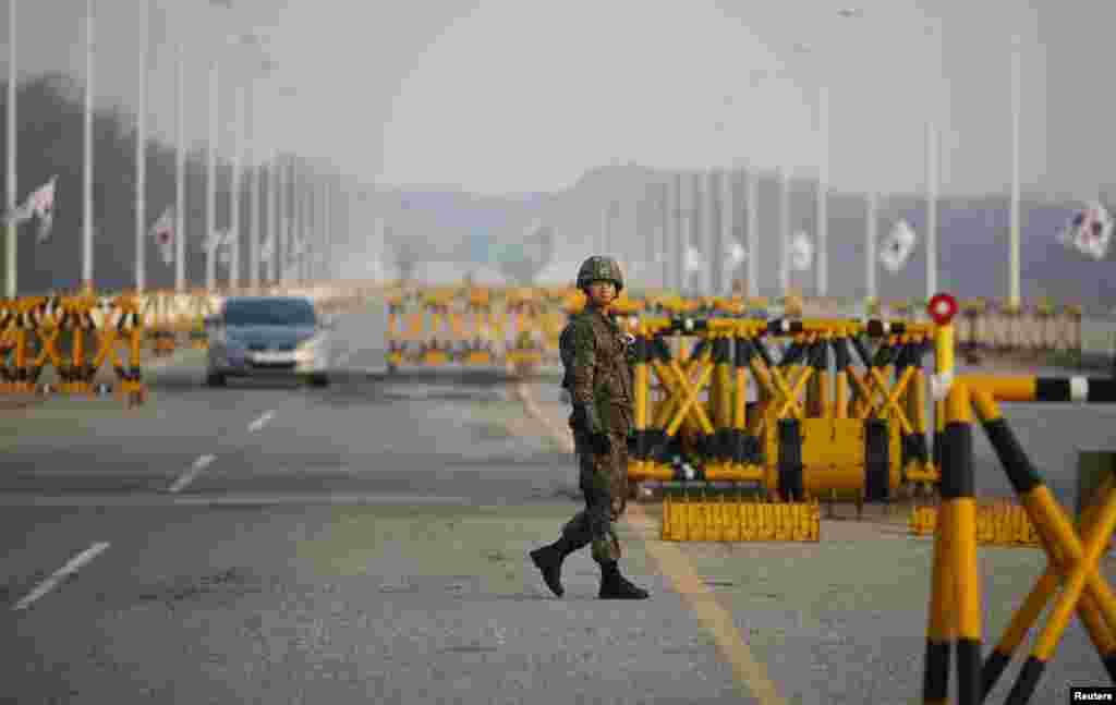 A South Korean soldier patrols at a checkpoint on the Grand Unification Bridge, which leads to the demilitarized zone separating North Korea from South Korea, in Paju, north of Seoul. 