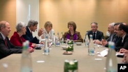 n this Nov. 9, 2013 photo, U.S. Secretary of State John Kerry, third left, meets with EU High Representative for Foreign Affairs, Catherine Ashton, center, and Iranian Foreign Minister Mohammad Javad Zarif, third right, at the Iran Nuclear talks in Genev