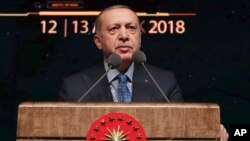 Turkey's President Recep Tayyip Erdogan delivers a speech in Ankara, Turkey, Dec. 12, 2018. Erdogan said Turkey will begin "within a few days" a new military operation to drive out U.S.-backed Syrian Kurdish fighters in Syria, east of the Euphrates River.