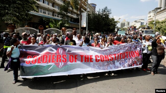 FILE - Members of Kenya's ruling Jubilee coalition demonstrate in support of the Independent Electoral and Boundaries Commission (IEBC) the electoral body ahead of next year's election in Nairobi, June 8, 2016. 