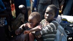 A girl holds a young child shortly after arriving at a U.N. camp for the displaced in the Unity state capital of Bentiu in June 2015. More than 2 million people have been displaced by 20 months of fighting. 