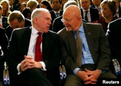 FILE - Then CIA Director John Brennan (L) speaks to then Director of National Intelligence James Clapper at the Justice Department in Washington, Jan. 17, 2014.